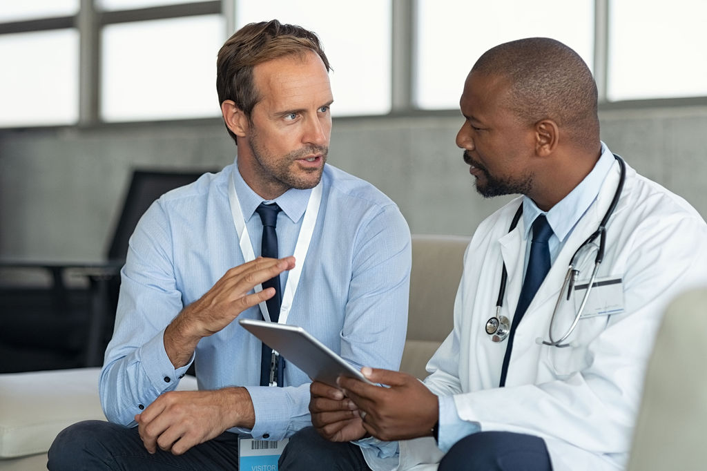 Two clinicians talking between appointments