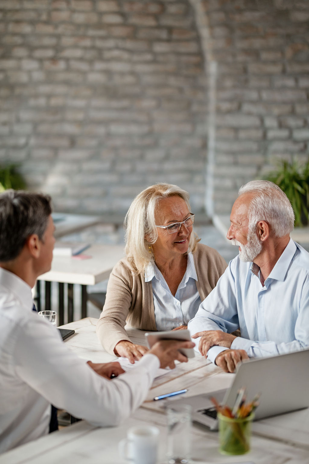 A couple reviewing documents with their advisor