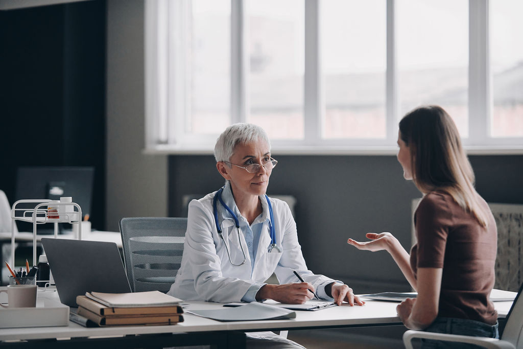 A physician listening to a patient