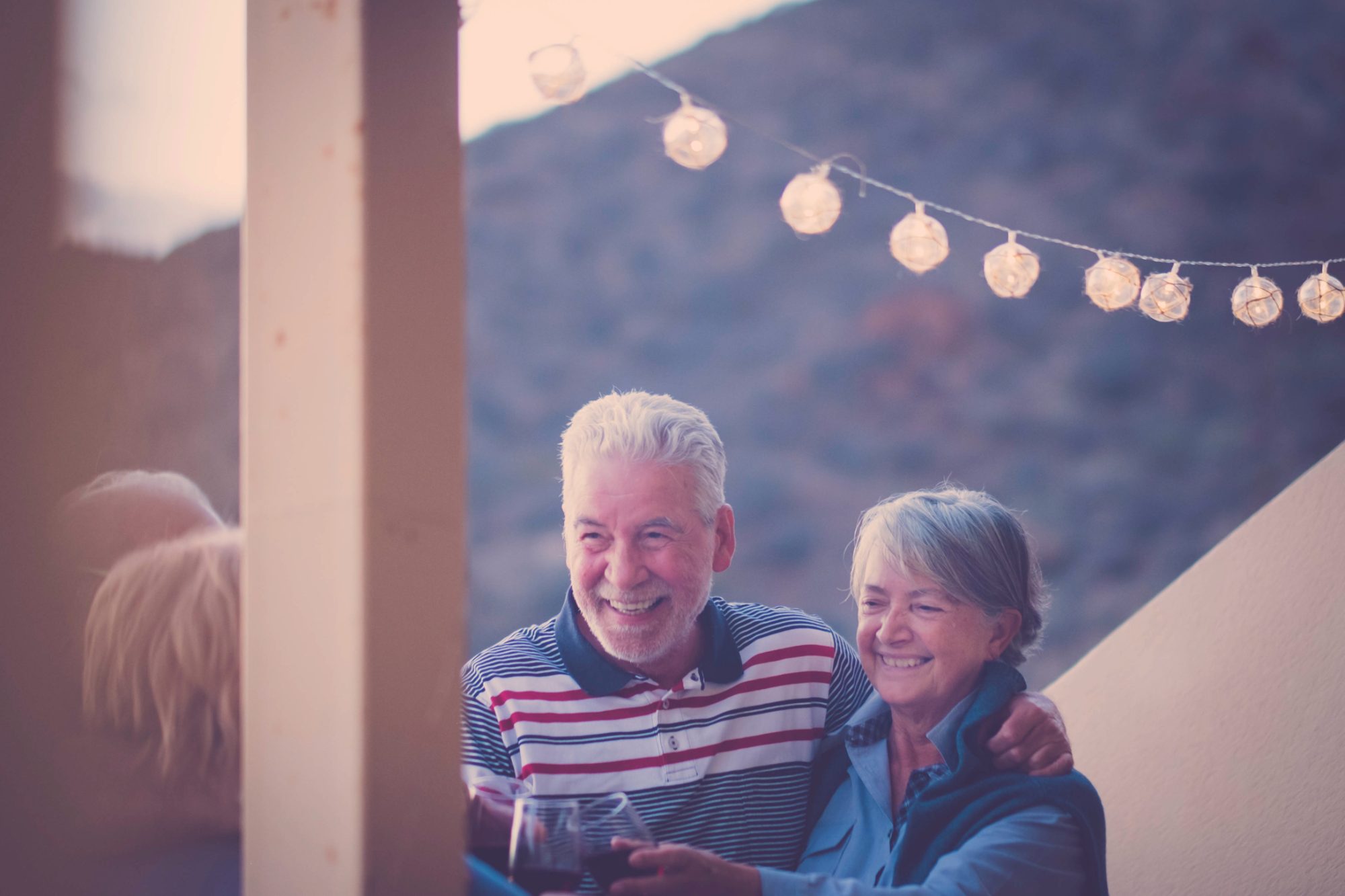 A couple hosting friends on their terrace